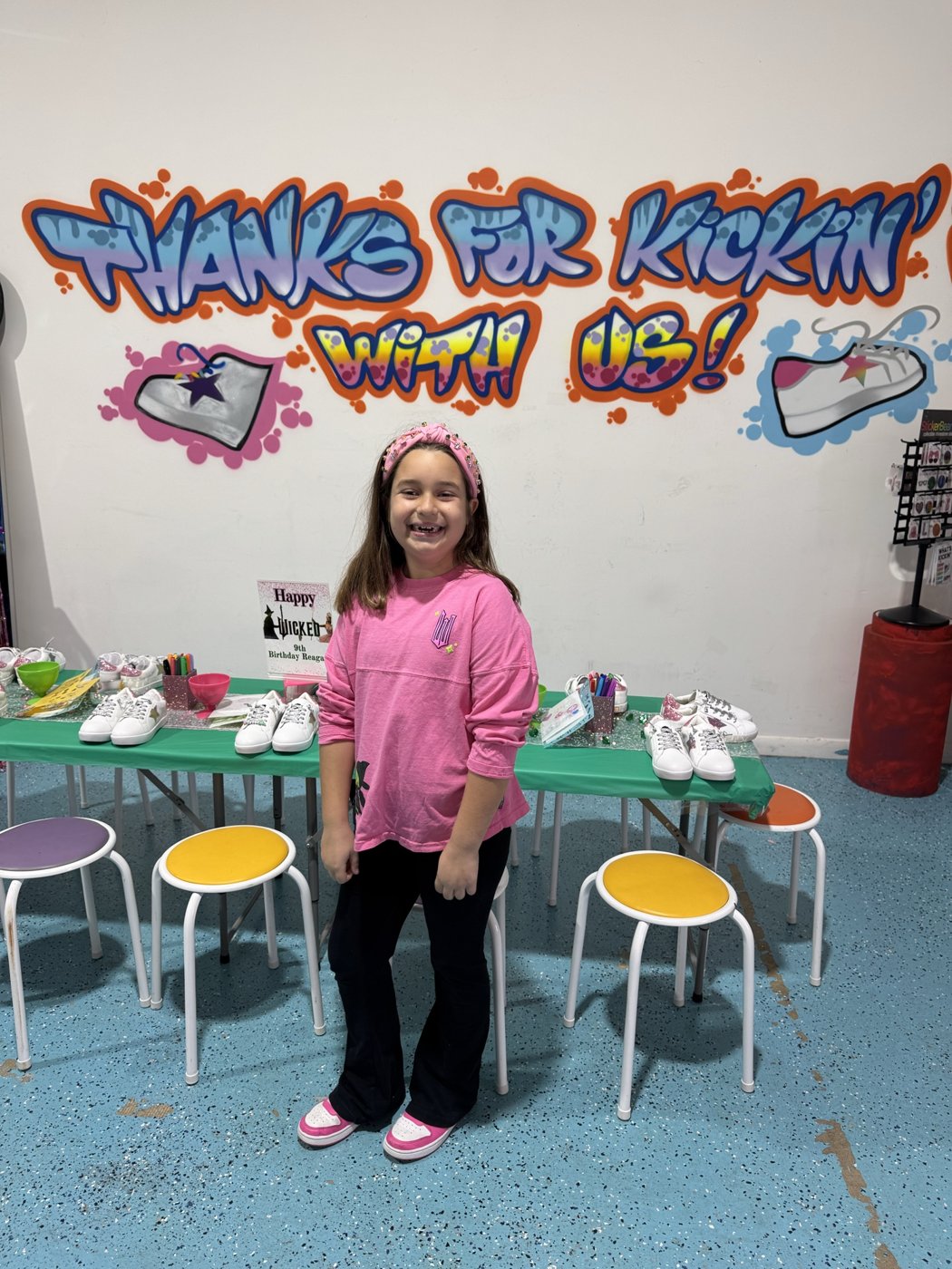 Birthday girl in front of the StyleChild graffiti wall