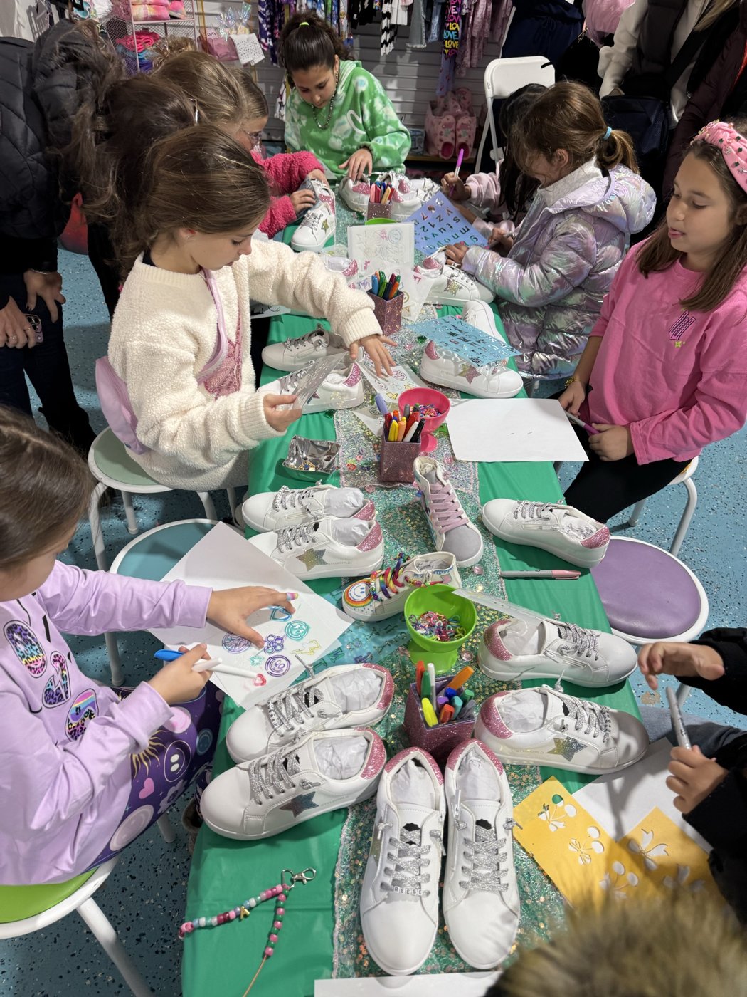 Kids decorating sneakers together at StyleChild HQ