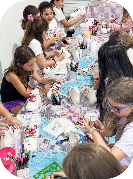 Kids customizing white sneakers at a StyleChild party