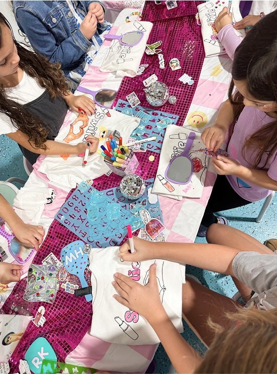 Kids decorating t-shirts with stencils