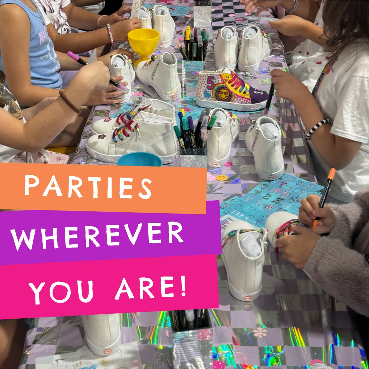 Party table with white sneakers and markers